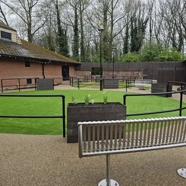 Resin bound courtyard with seating and accessible pathways at care home