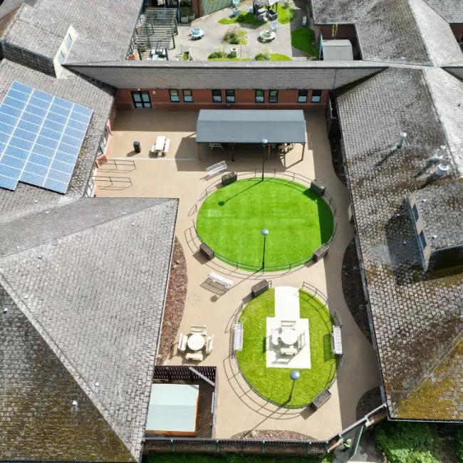 Drone view of resin bound surfacing project at care home with pathways, seating and outdoor spaces