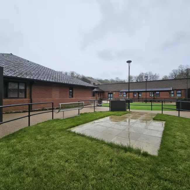 Resin bound pathways and accessible courtyard at care home with seating and landscaped areas