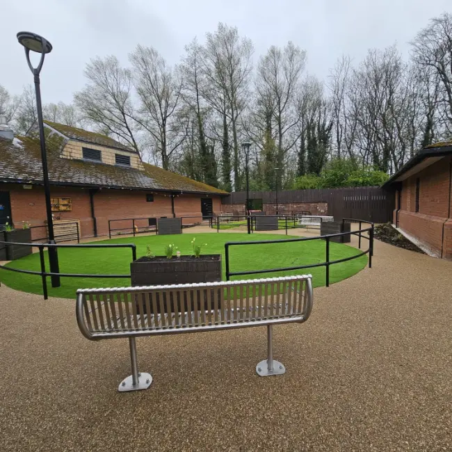 Commercial resin bound surfacing with seating area and curved accessible pathways at care home