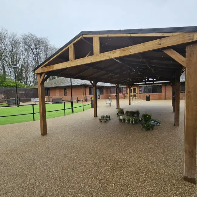 Resin bound surfacing under covered walkway in care home courtyard