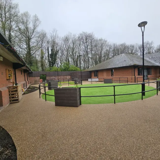 Commercial resin bound surfacing with curved pathways and central courtyard at care home