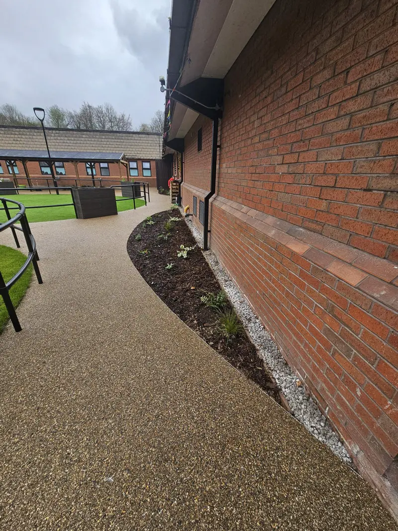 Resin bound pathway with curved edging along care home building