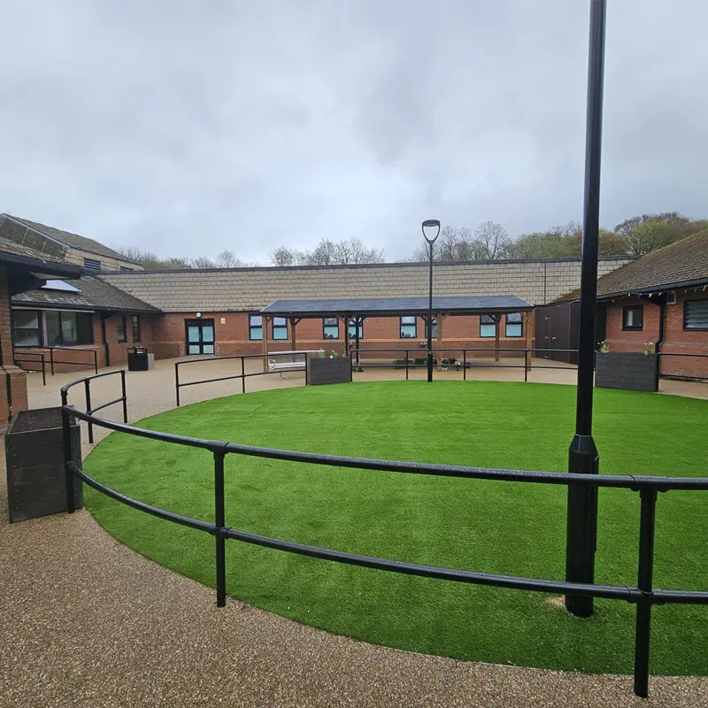 Resin bound courtyard with accessible pathways and central green space at care home