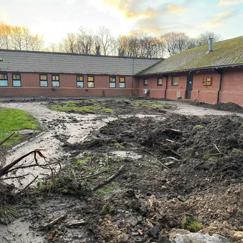 Before resin bound installation showing muddy courtyard at care home in Wigan