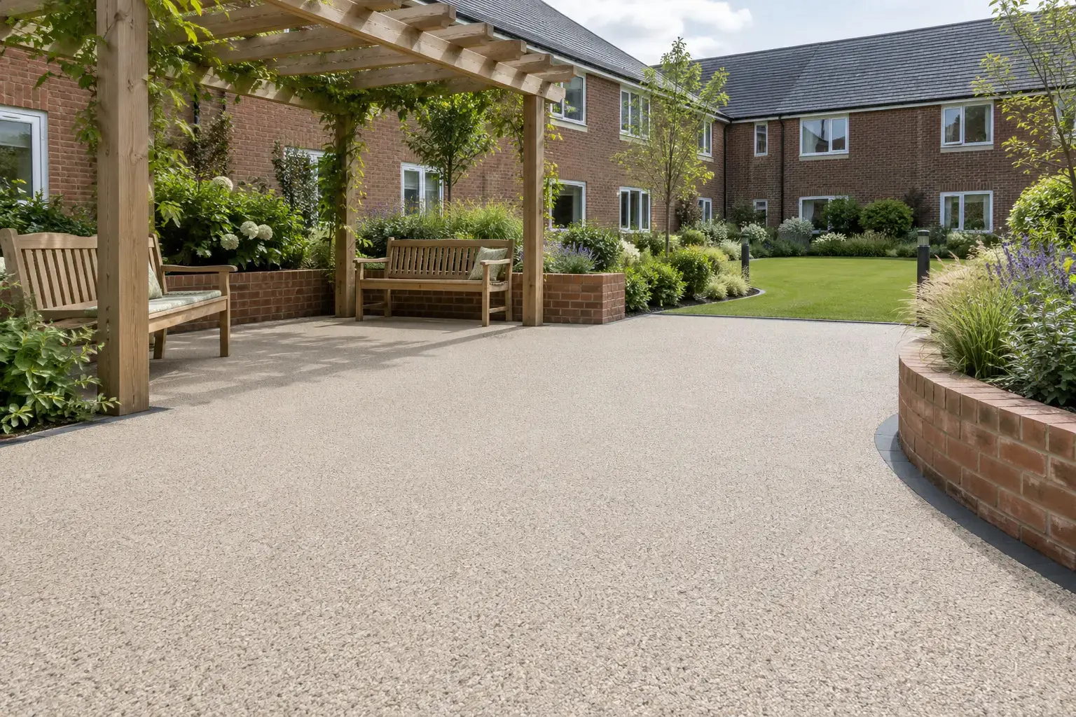 Illustrative resin bound courtyard beneath a timber pergola, with benches and raised planting beds.